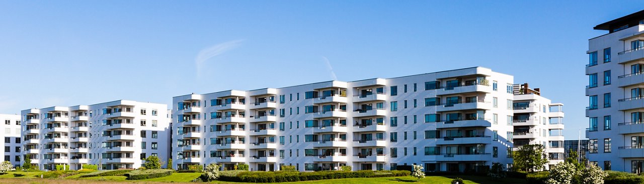 Modern white danish residential condominium building near Copenhagen, Denmark on a sunny day.